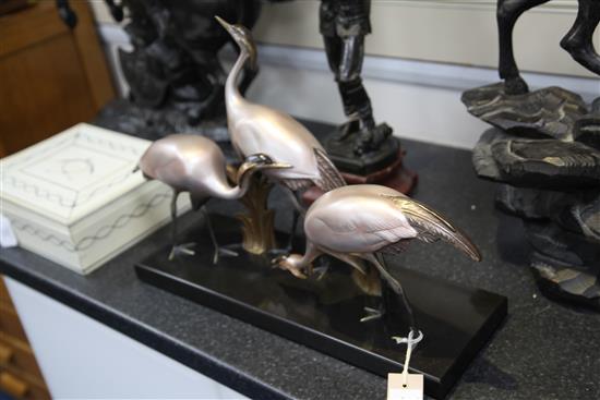 Armand Sinko. A French Art Deco patinated and cold painted bronze figure group of three cranes(-)